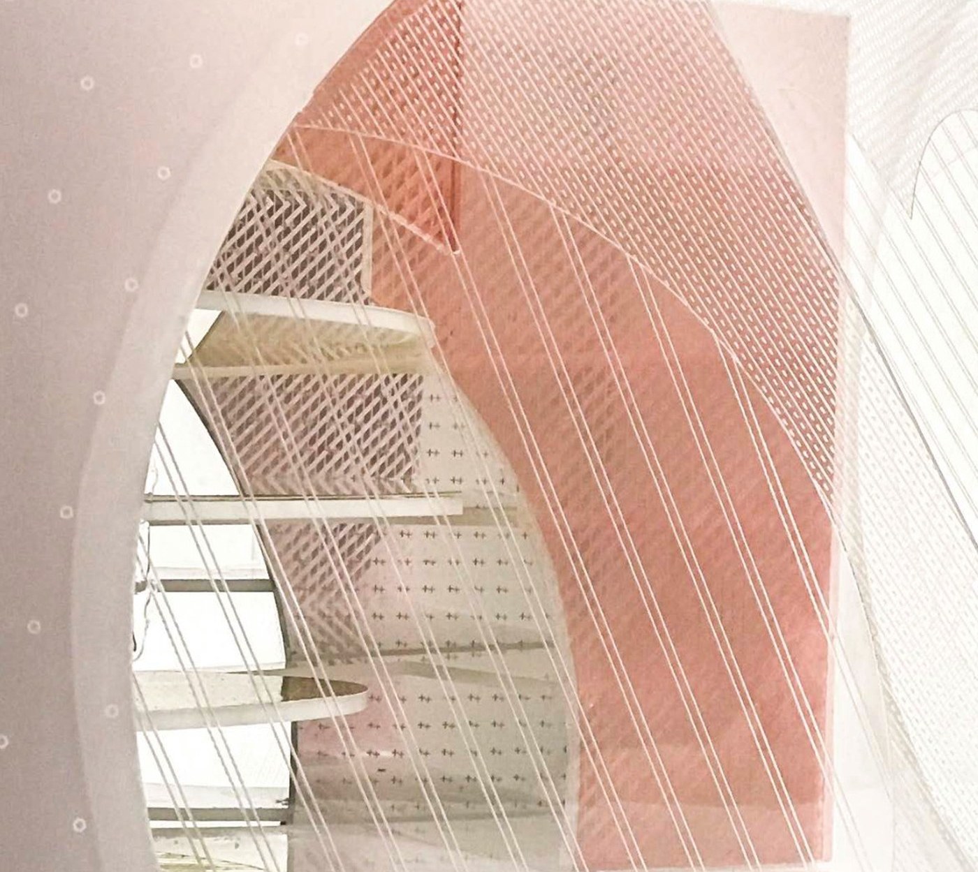 Physical model — interior view through arch, pink mesh panels and staircase